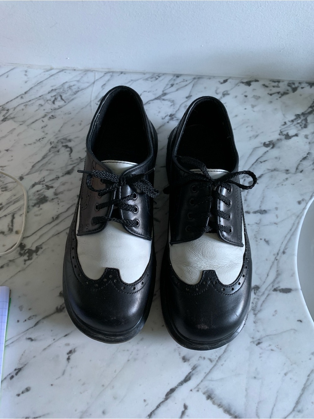 Men’s Dr. Martens Black and White Leather Wingtip Oxfords.